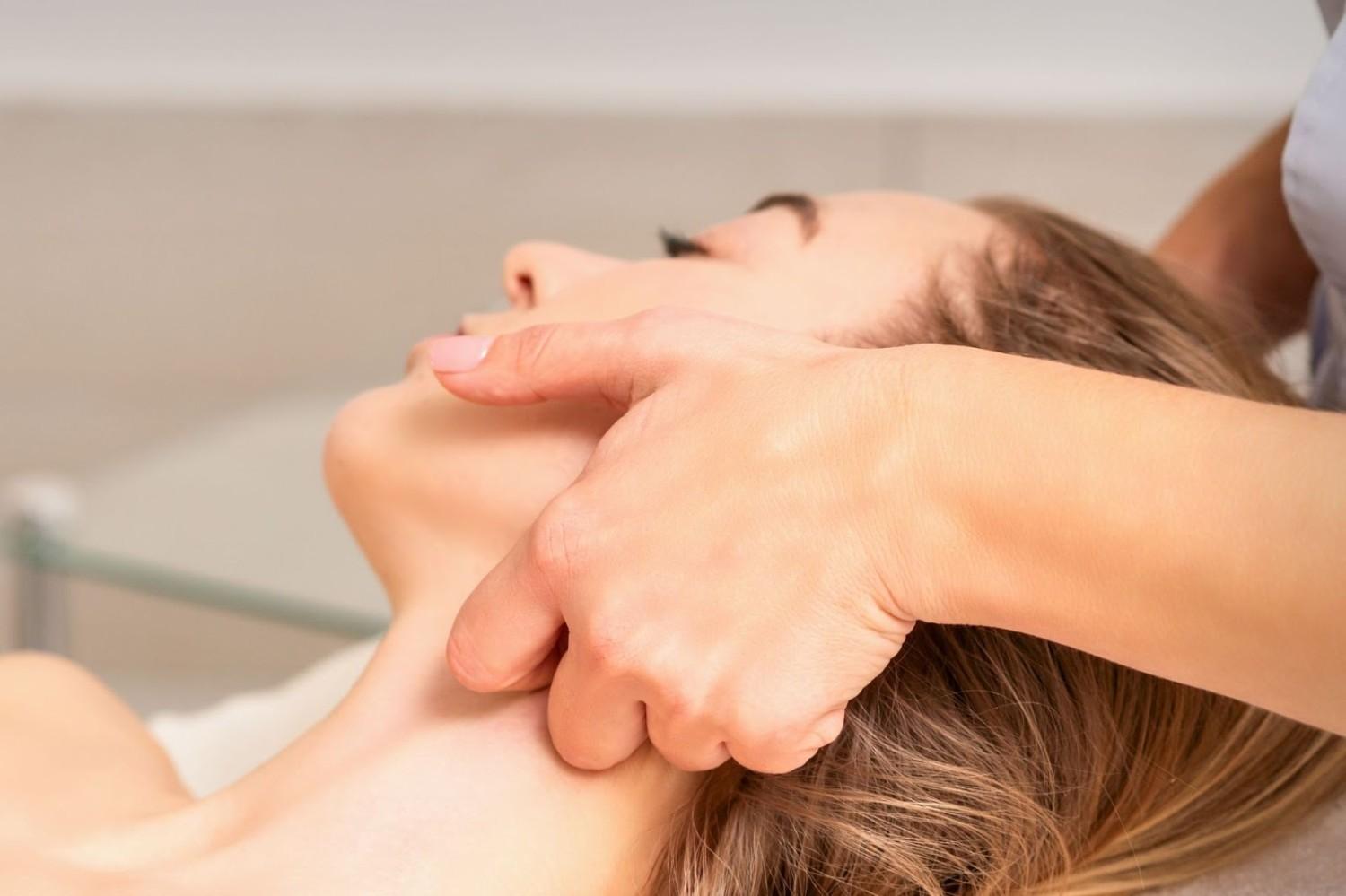 An esthetician performing a facial lymphatic massage at Lymphatic Therapy Services' San Diego clinic.