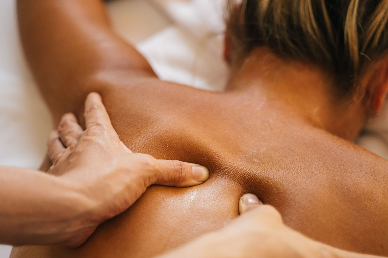 Client receiving lymphatic drainage therapy to help manage fibromyalgia pain and promote symptom relief.