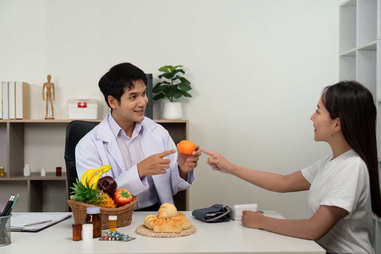 Doctor advising a patient on nutrition with fruits to support lymphatic health and reduce swelling.