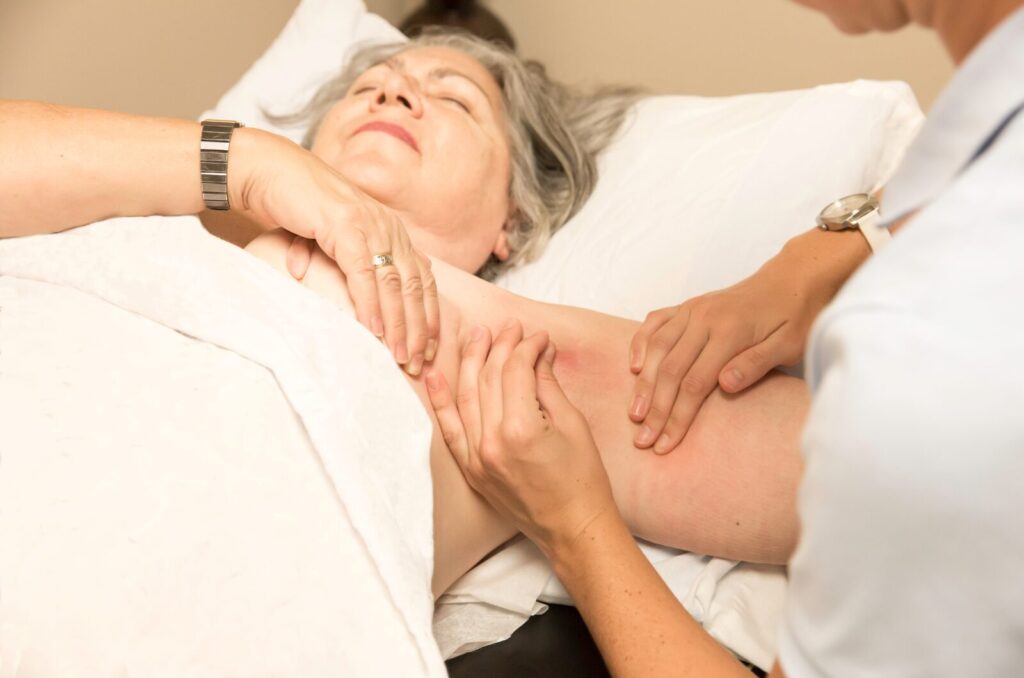 Therapist giving gentle lymphatic drainage massage on chest area to reduce swelling and support recovery after surgery