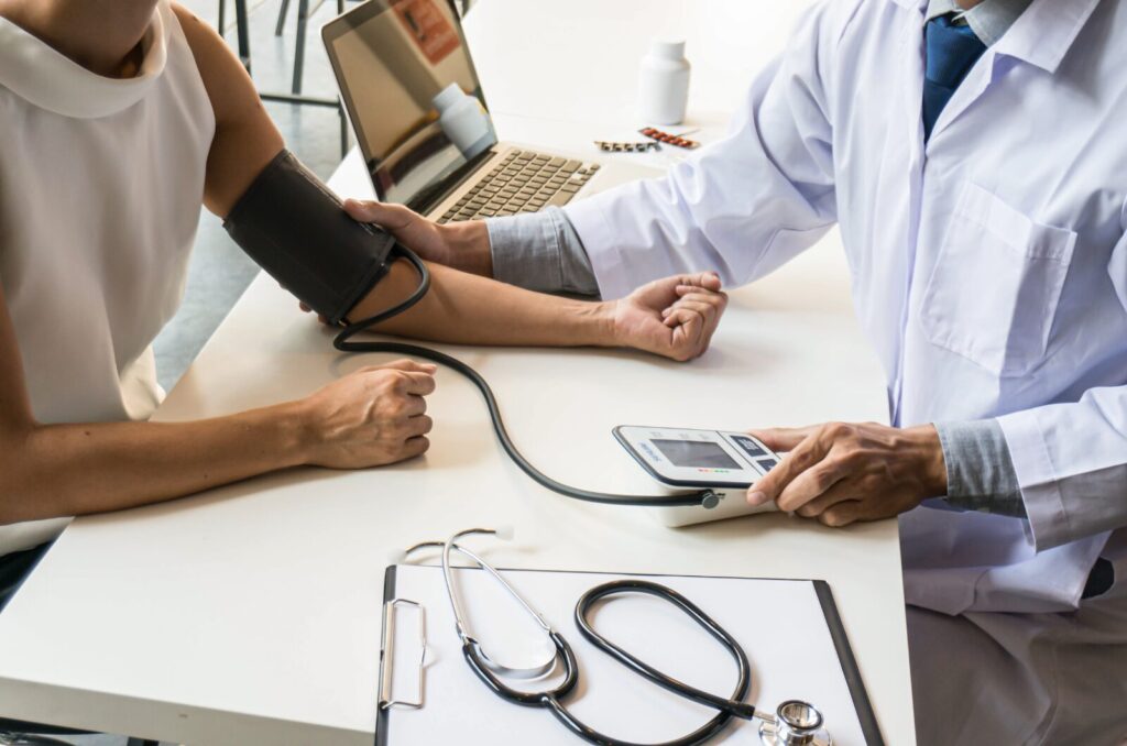 Doctor measuring patientโs blood pressure during a health check related to circulation and lymphatic health